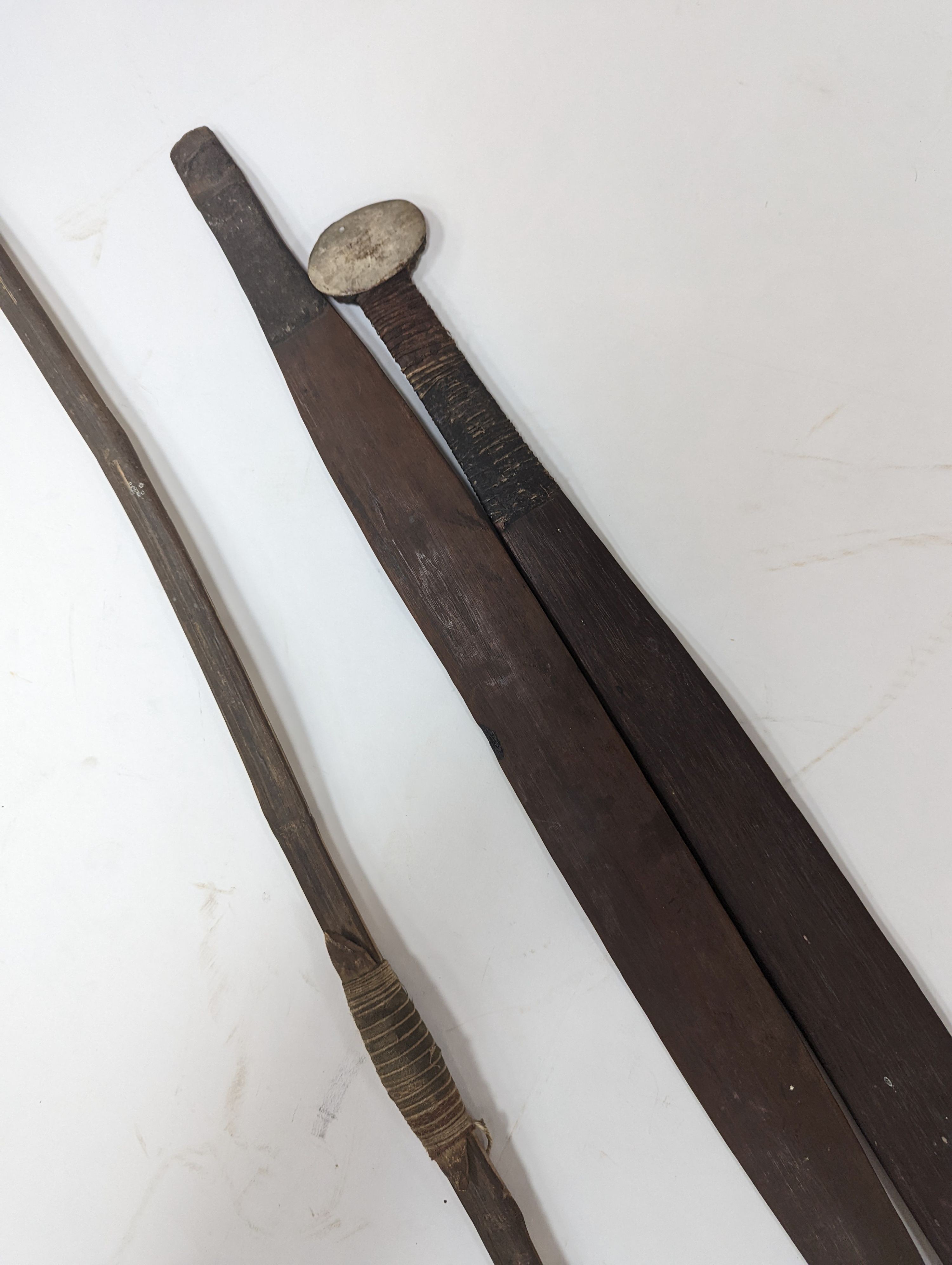 Two chip-carved paddle blades and bow, possibly Fijian.